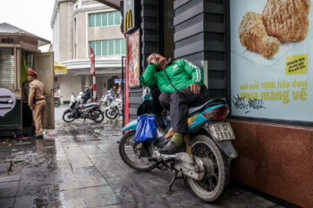 A man on a motorcycle in Vietnam.