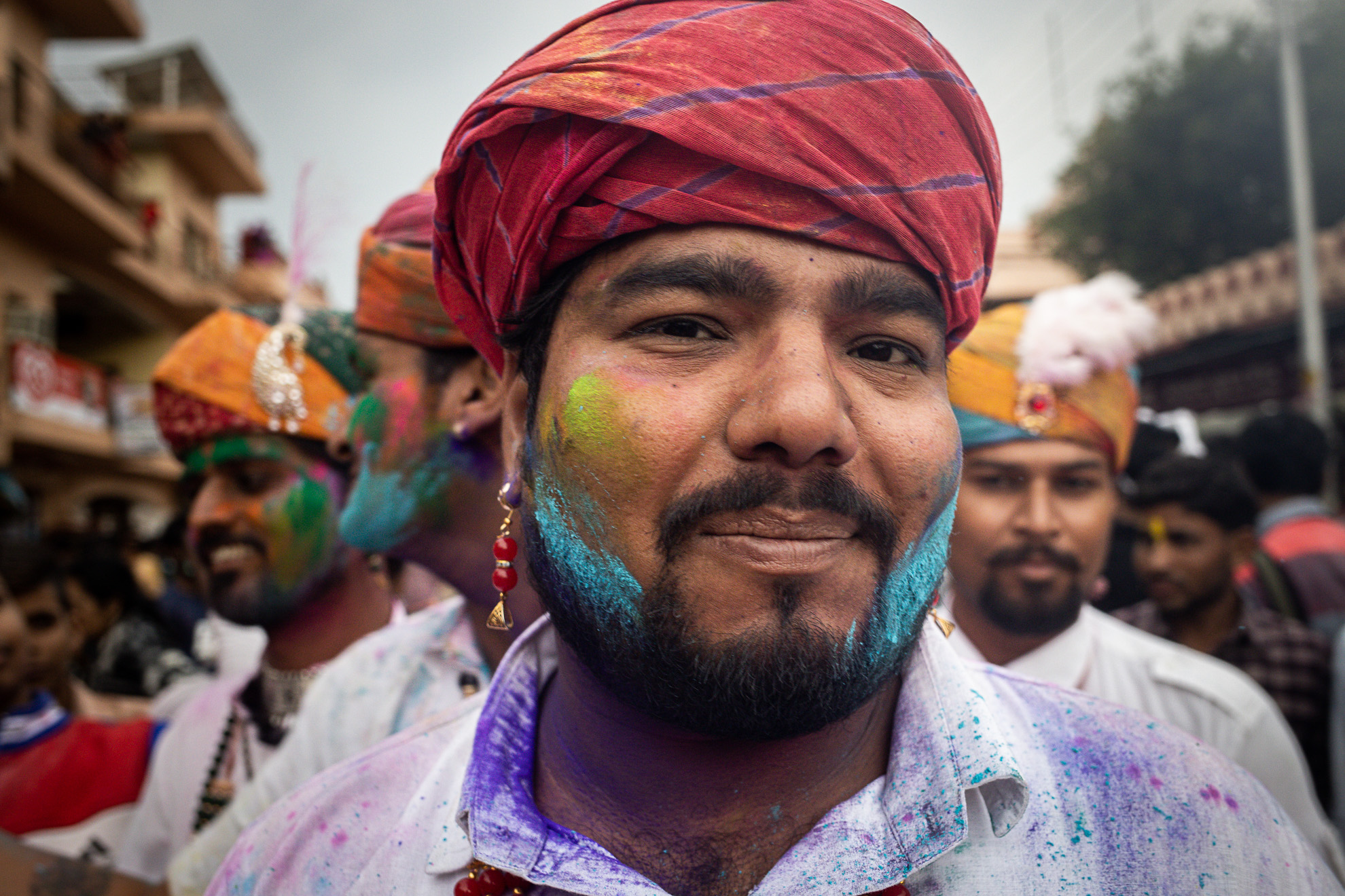 Un homme portant un turban avec de la peinture colorée sur le visage en Inde.